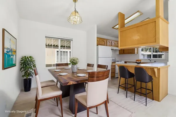 a view of a dining room with furniture and chandelier