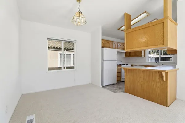 a kitchen with stainless steel appliances granite countertop a sink a stove and a refrigerator