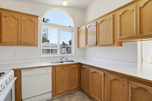 a kitchen with a sink cabinets and window