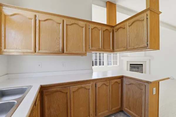 a kitchen with stainless steel appliances granite countertop a sink a refrigerator and cabinets