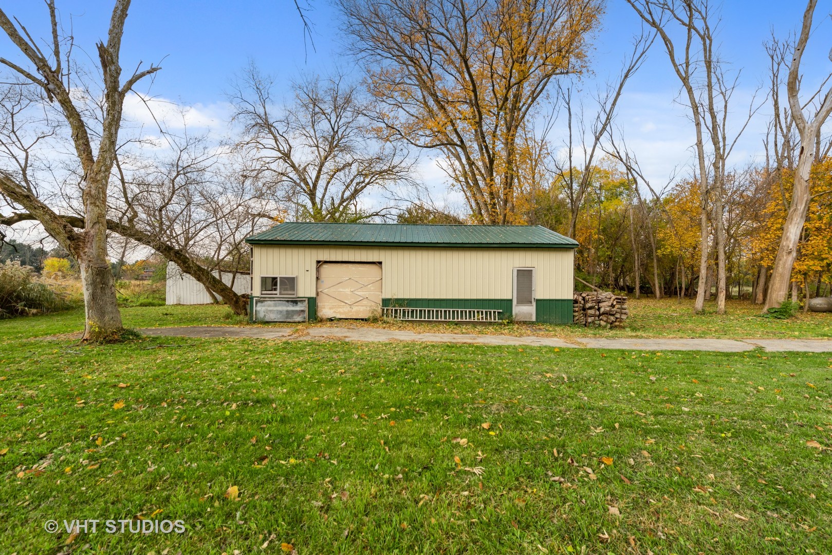 18607 McGuire Road Harvard, IL 60033 - Photo 5 of 14 a view of a house with a large tree and a big yard