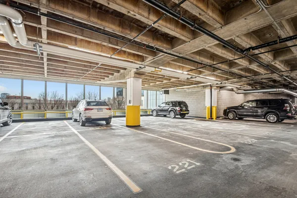 a view of parking garage with cars