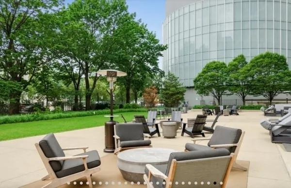 a view of a patio with couches chairs and a fire pit