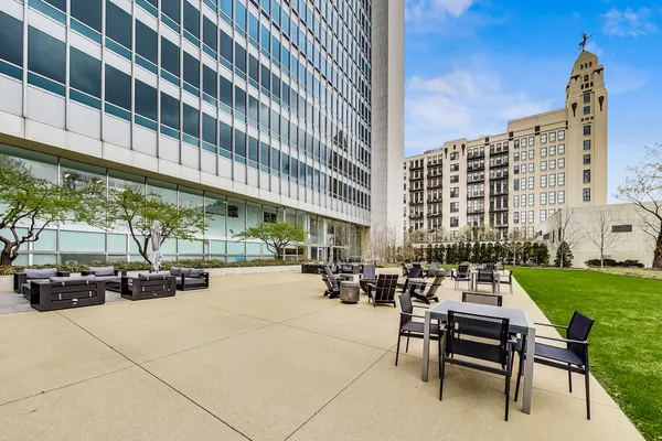 a roof deck view with lawn chairs and a barbeque