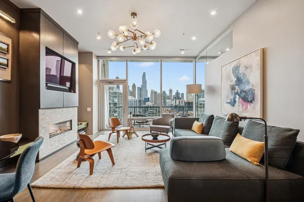 a living room with furniture and a chandelier