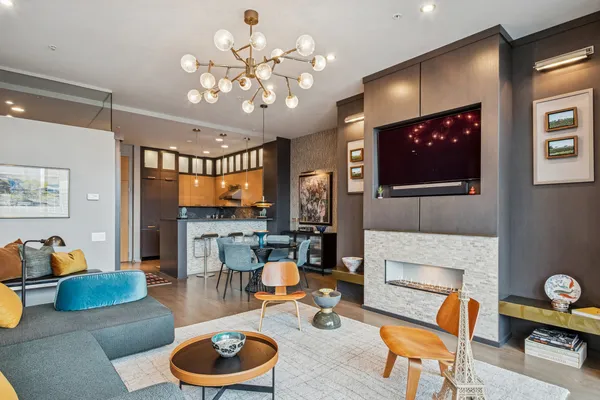 a living room with furniture a fireplace and a flat screen tv