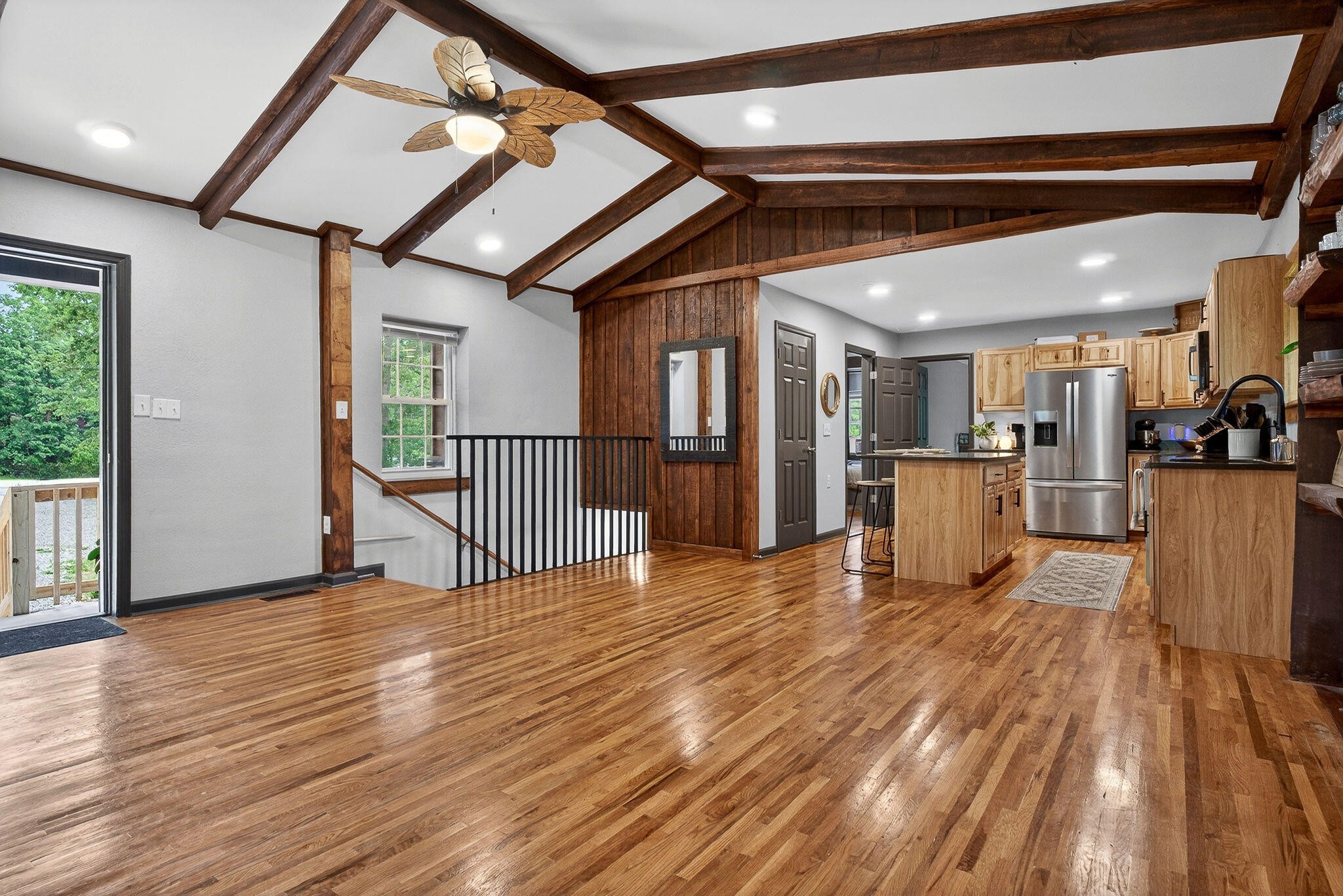 9388 Harrison Ferry Road McMinnville, TN 37110 - Photo 7 of 41 a view of a livingroom with furniture a ceiling fan and wooden floor