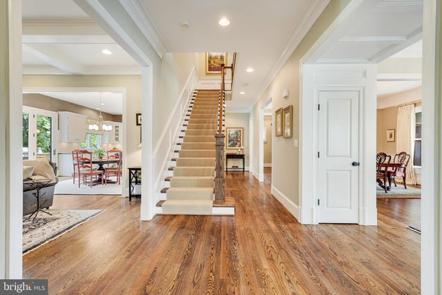 a kitchen with stainless steel appliances kitchen island granite countertop a dining table chairs and sink