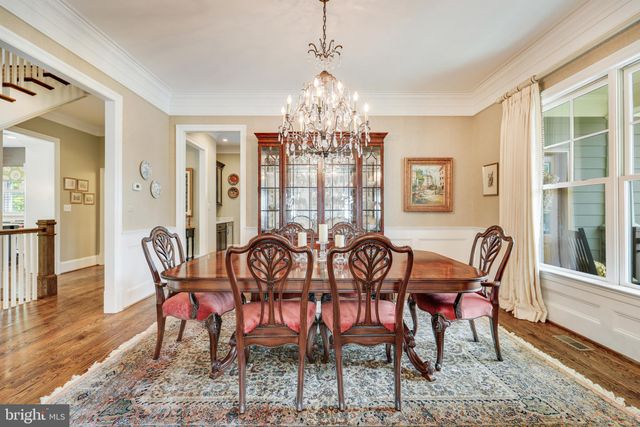 a kitchen with granite countertop a stove a sink and wooden cabinets