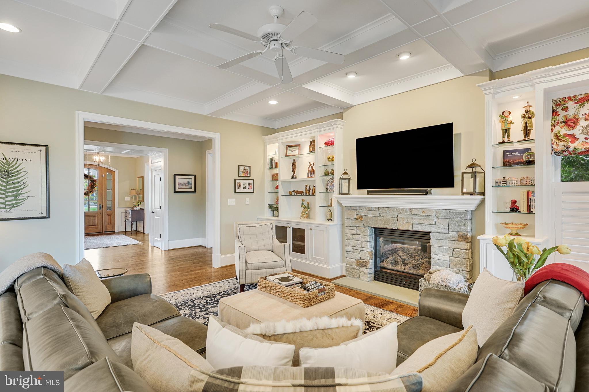 1415 Kurtz Road McLean, VA 22101 - Photo 24 of 129 a living room with furniture a fireplace and a flat screen tv