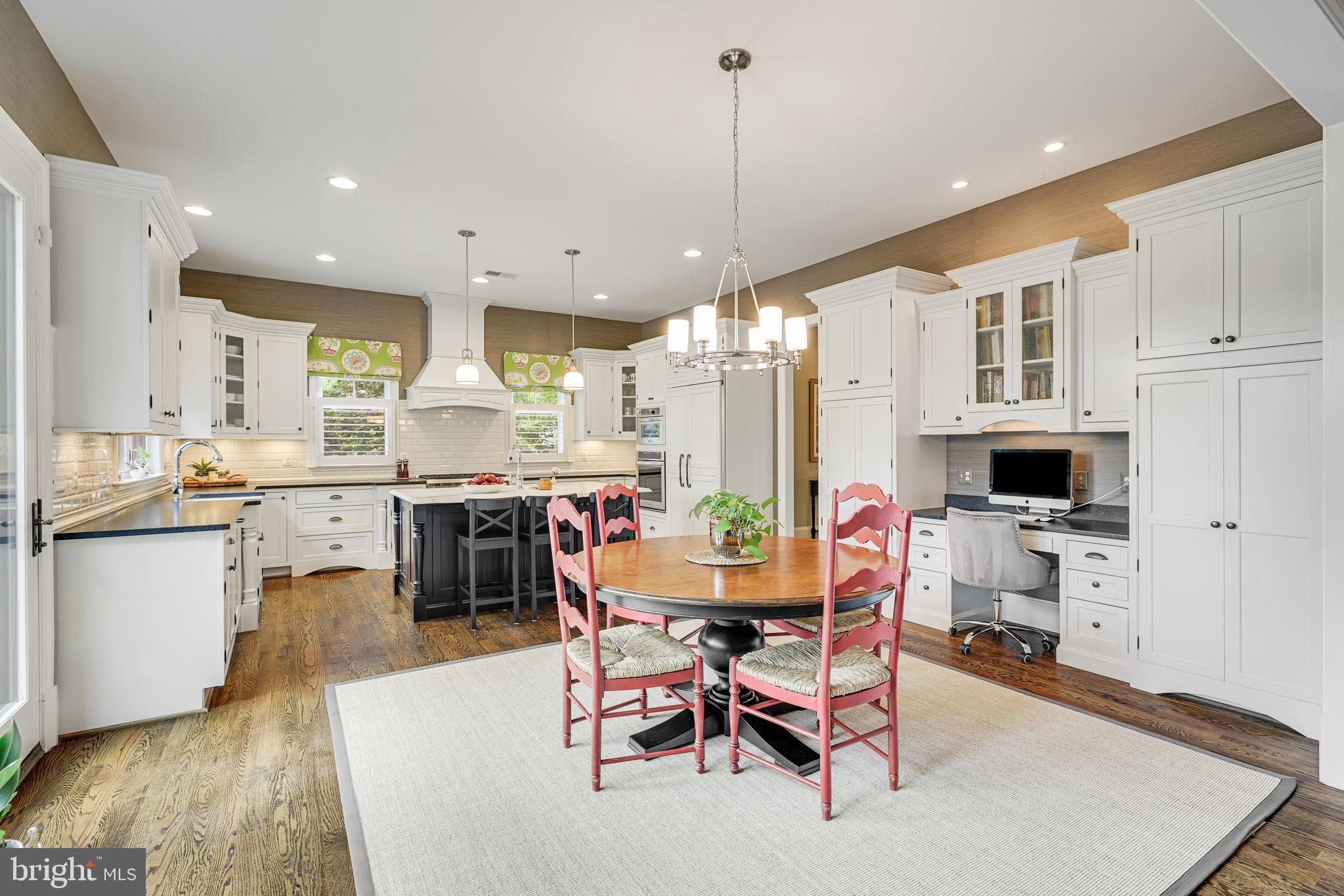 1415 Kurtz Road McLean, VA 22101 - Photo 26 of 129 a kitchen with stainless steel appliances kitchen island granite countertop a dining table chairs and sink