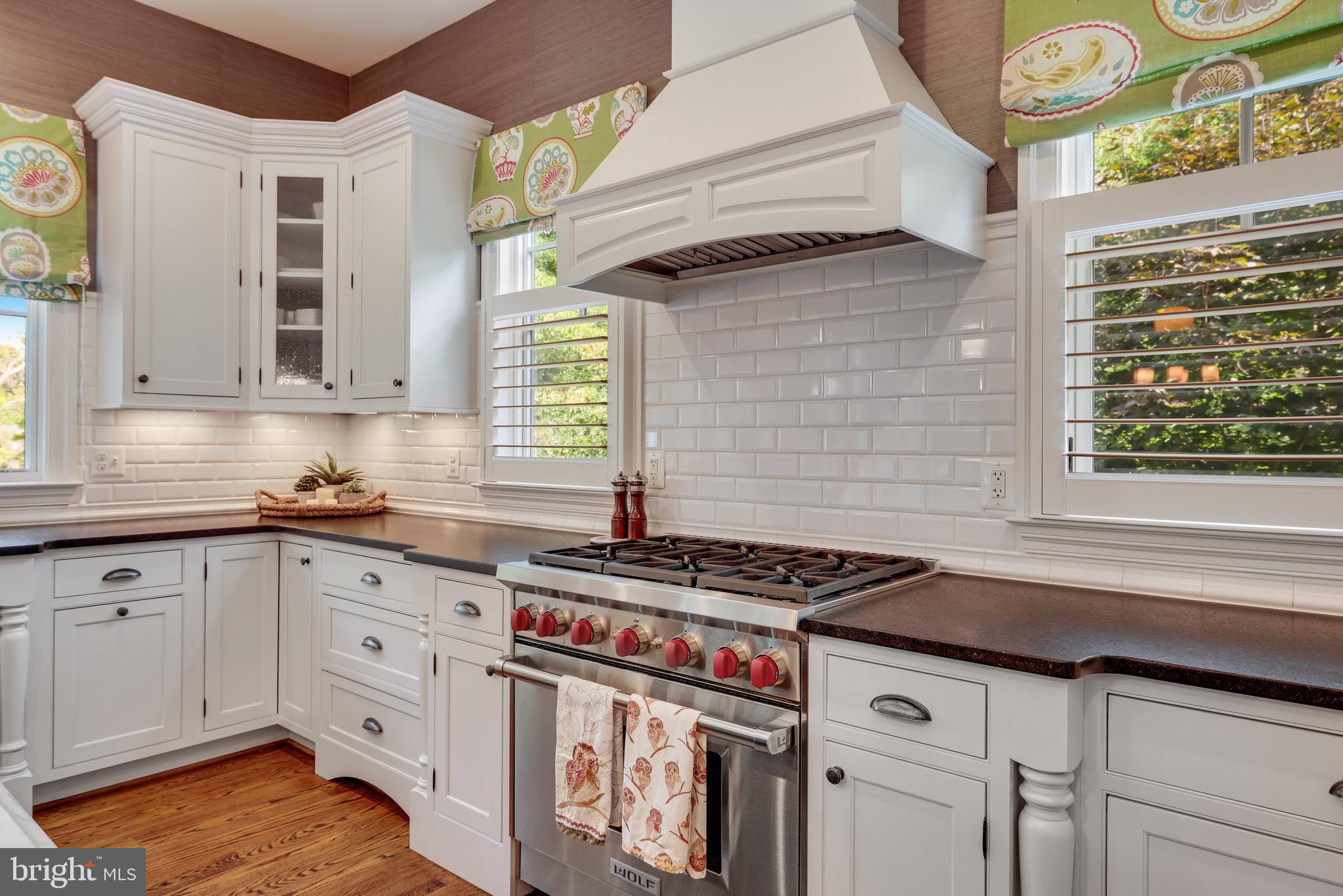 1415 Kurtz Road McLean, VA 22101 - Photo 32 of 129 a kitchen with granite countertop a stove a sink and wooden cabinets
