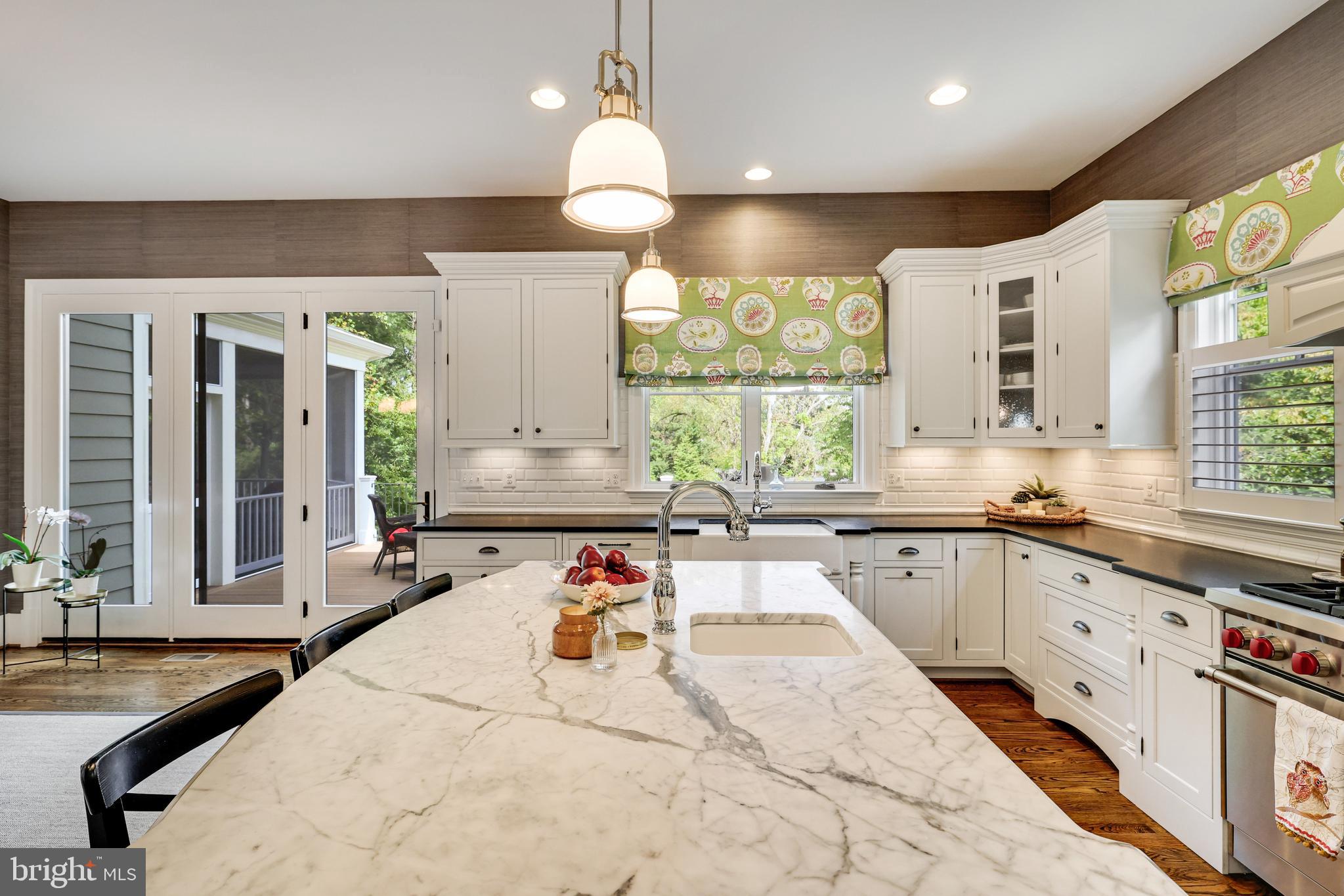 1415 Kurtz Road McLean, VA 22101 - Photo 33 of 129 a large kitchen with kitchen island a large counter space a sink stainless steel appliances and windows