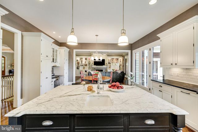 a spacious bedroom with a bed and a chandelier