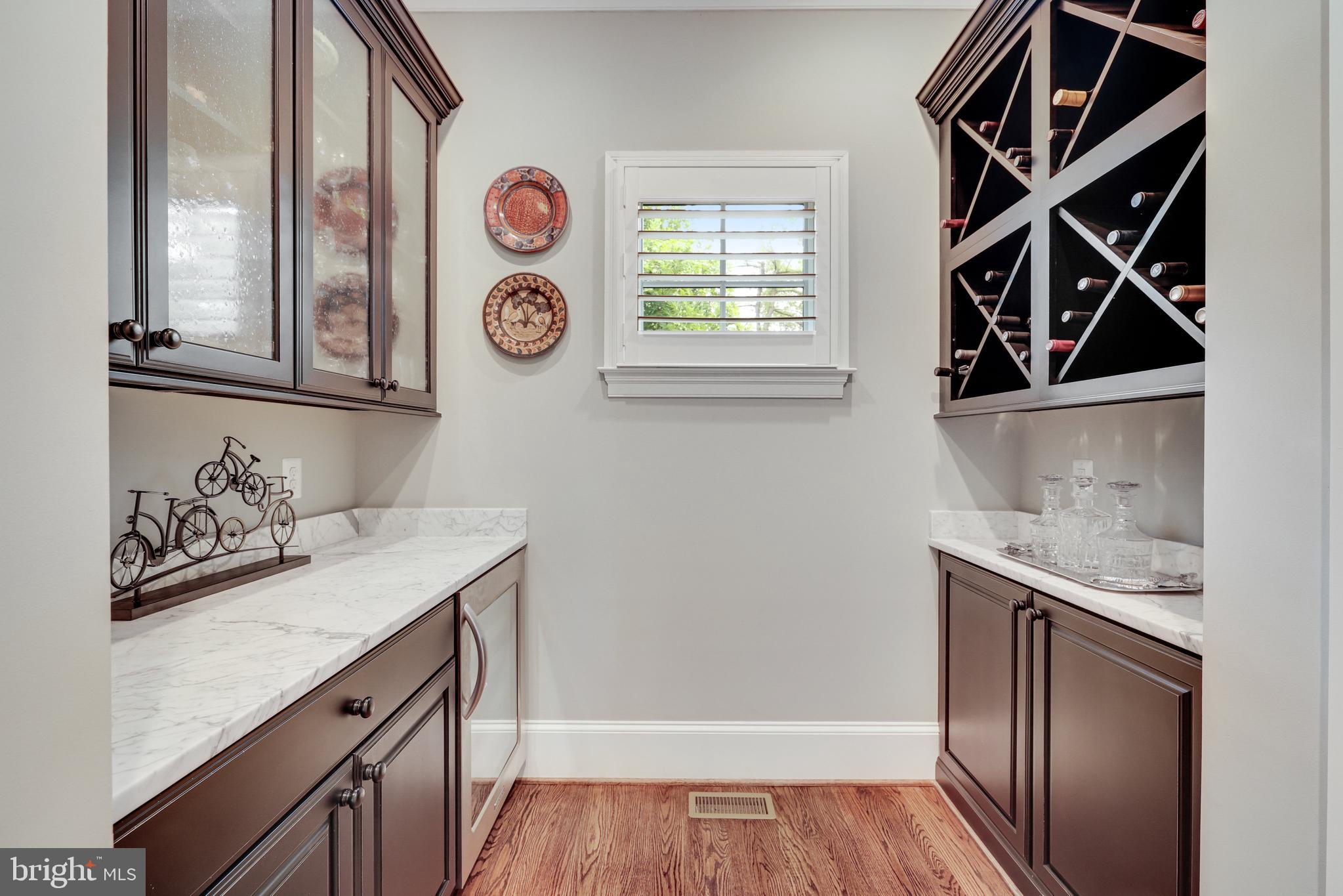 1415 Kurtz Road McLean, VA 22101 - Photo 37 of 129 a utility room with granite countertop a sink and a wooden floor