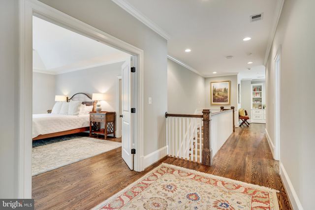a front view of a house with a yard and potted plants