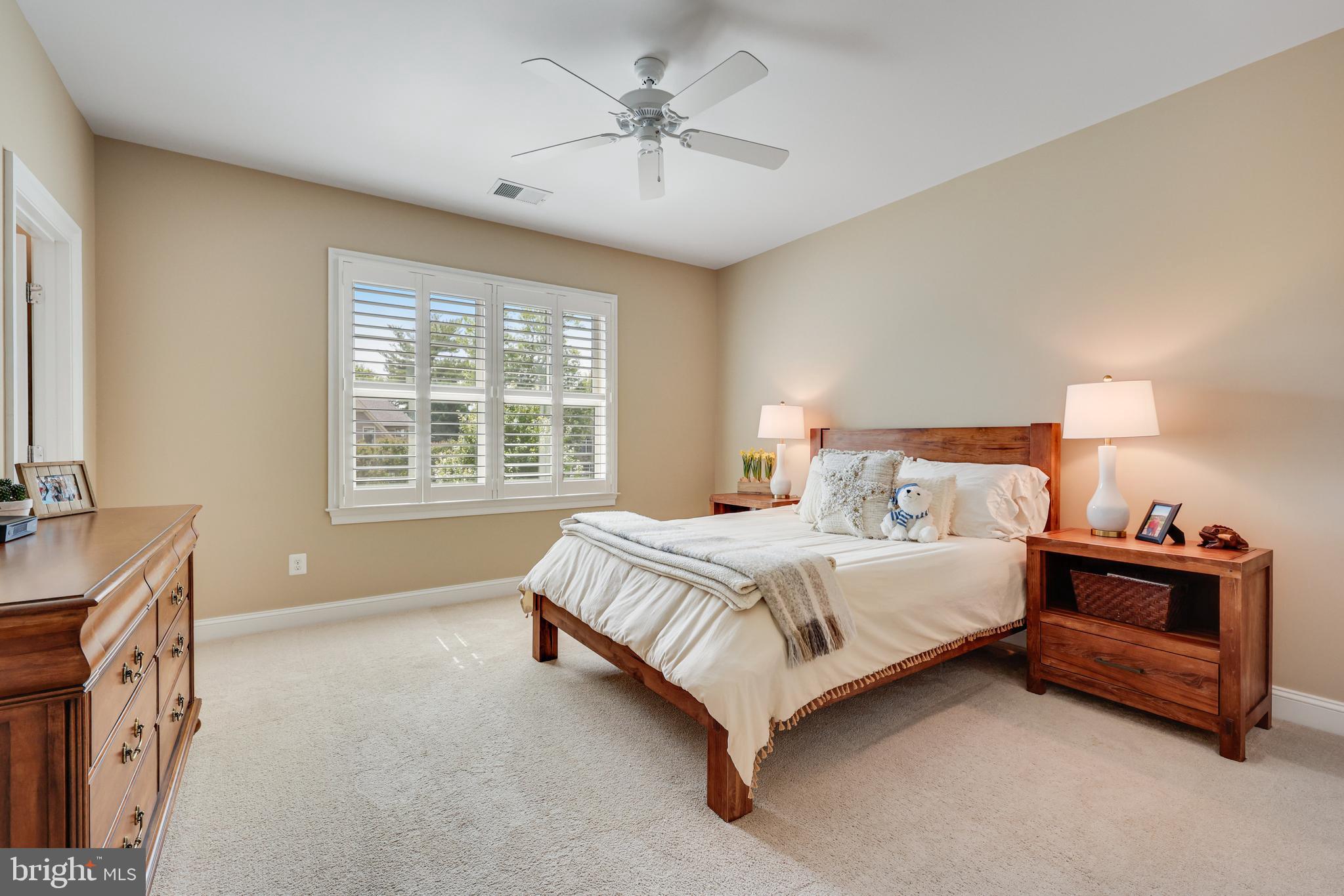 1415 Kurtz Road McLean, VA 22101 - Photo 58 of 129 a spacious bedroom with a bed and a chandelier
