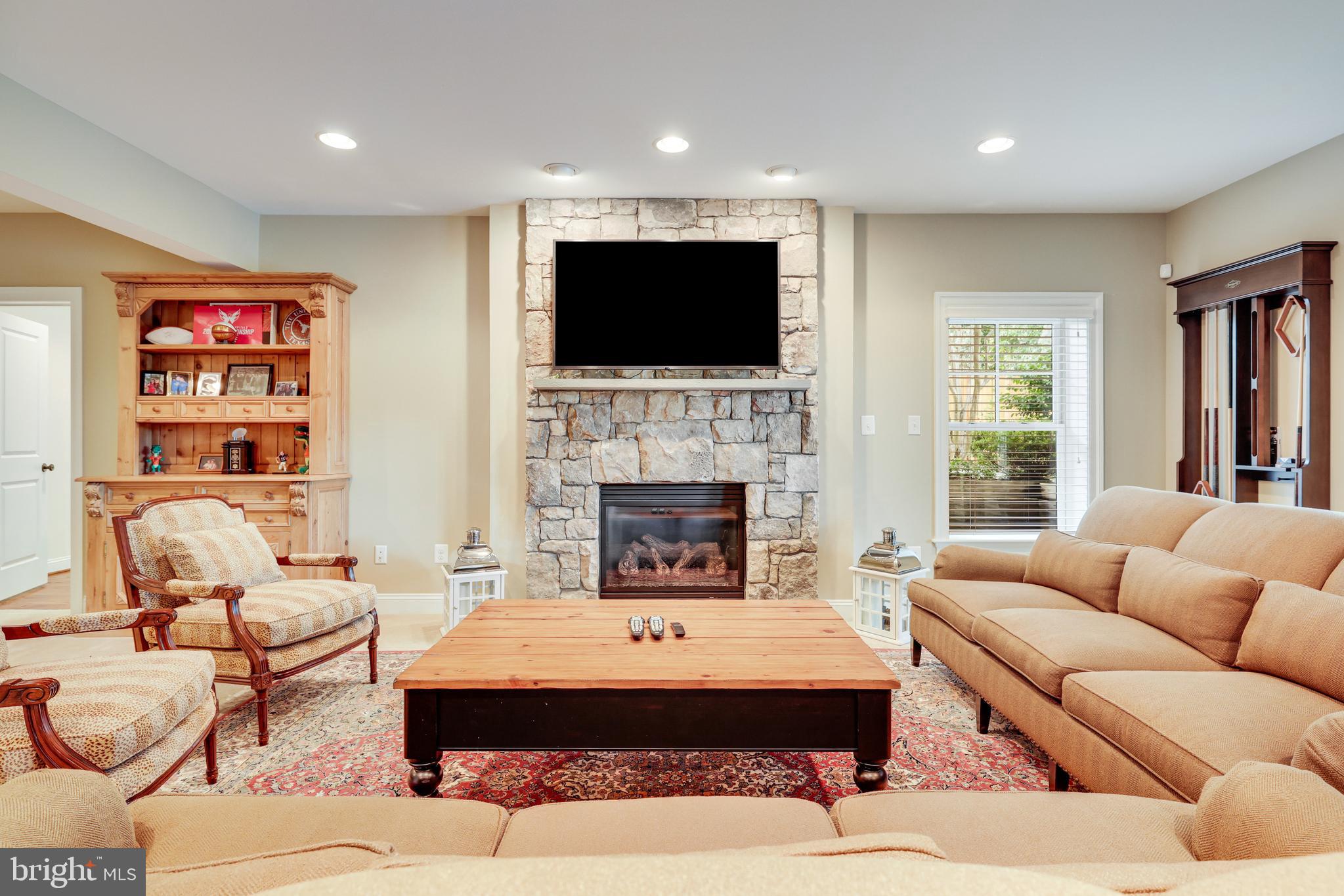 1415 Kurtz Road McLean, VA 22101 - Photo 75 of 129 a living room with furniture a flat screen tv and a fireplace