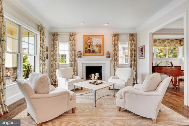a view of a dining room with furniture a chandelier and wooden floor