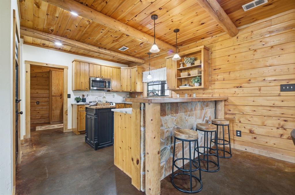 465 Emberson Ranch Road Pilot Point, TX 76258 - Photo 9 of 40 a kitchen with stainless steel appliances granite countertop a stove and a refrigerator