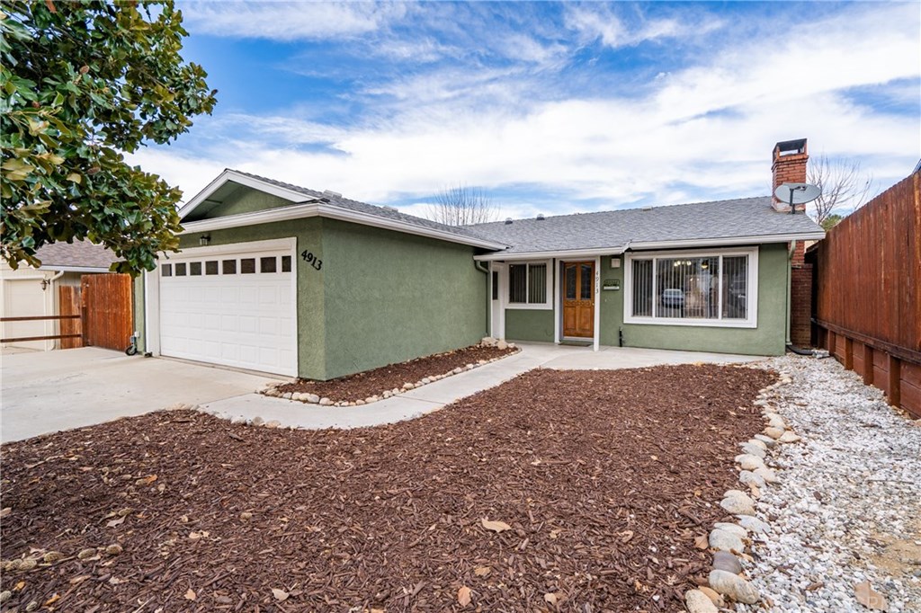 Nice curb appeal with clean white trim and low maintenance yard.