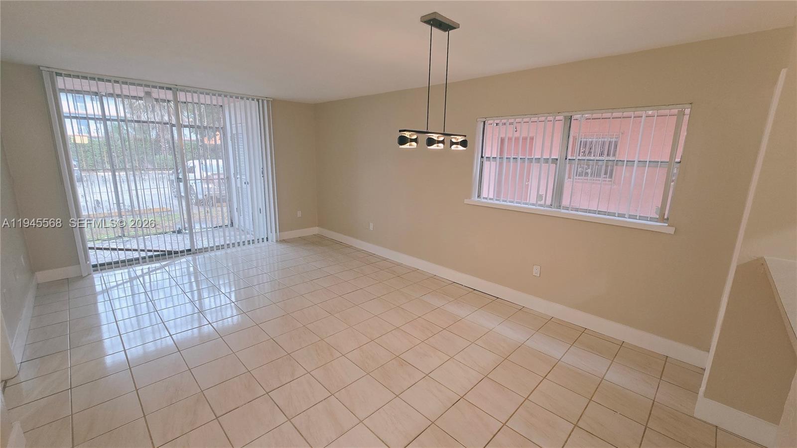 19791 Southwest 114th Avenue, Unit 131 Miami, FL 33157 - Photo 1 of 12 a view of an empty room with a window