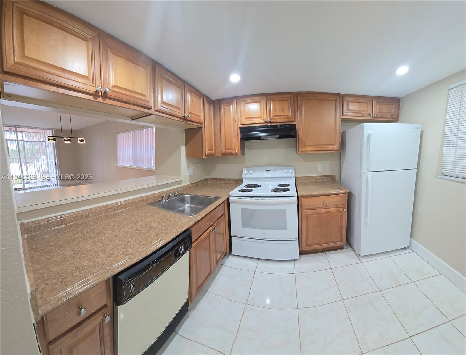 19791 Southwest 114th Avenue, Unit 131 Miami, FL 33157 - Photo 4 of 12 a kitchen with a stove a refrigerator and a sink