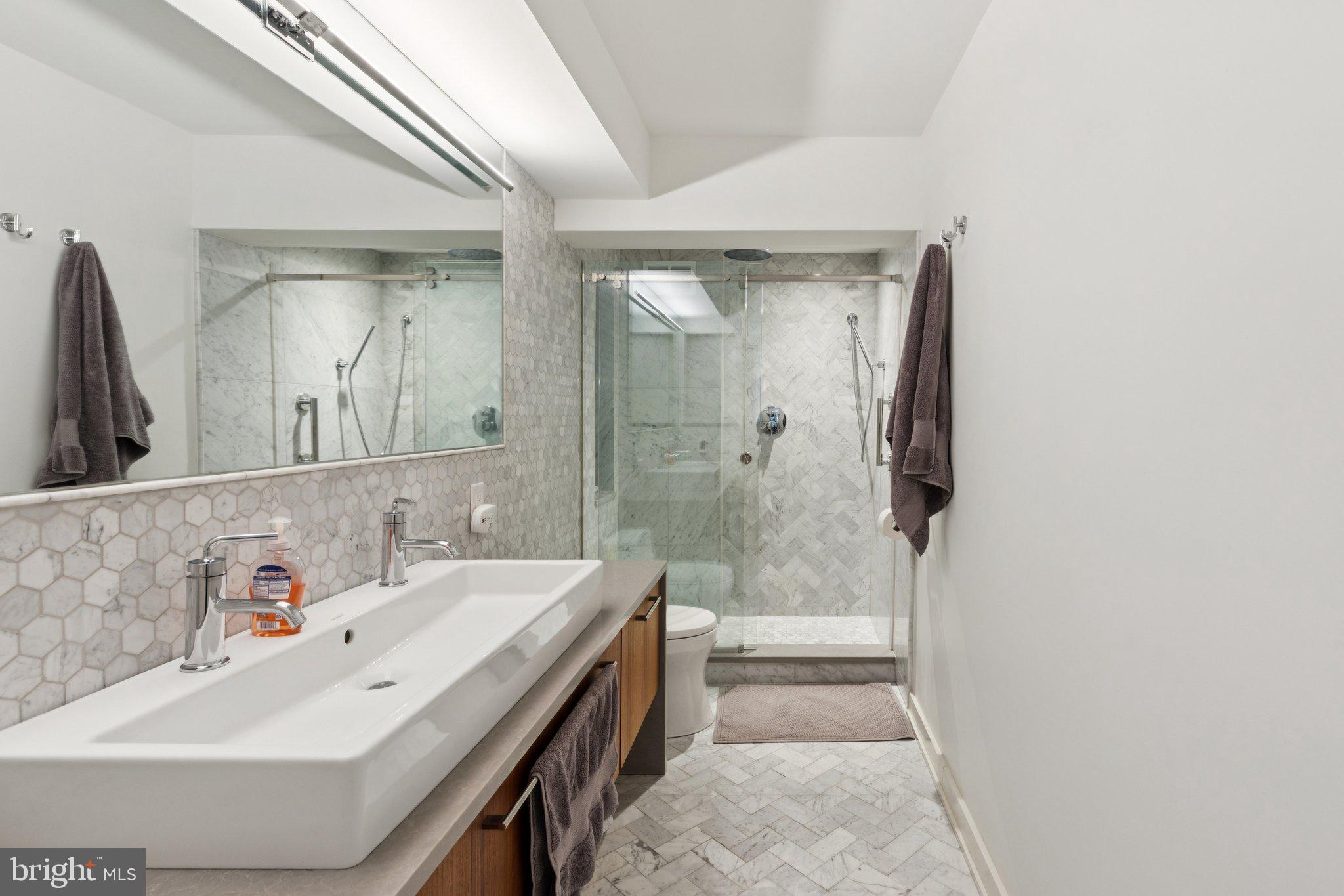 224 West Rittenhouse Square, Unit 1105 Philadelphia, PA 19103 - Photo 38 of 46 Sleek modern bathroom with elegant tiles.