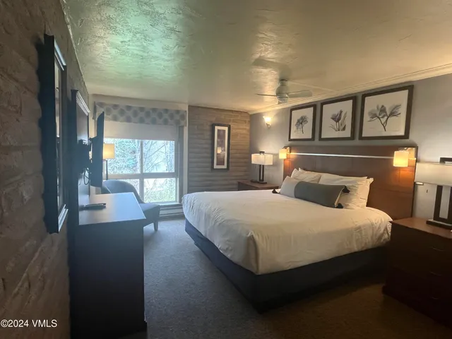 a bedroom with a large bed and a window