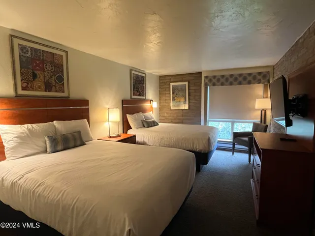 a bedroom with double bed and a flat screen tv