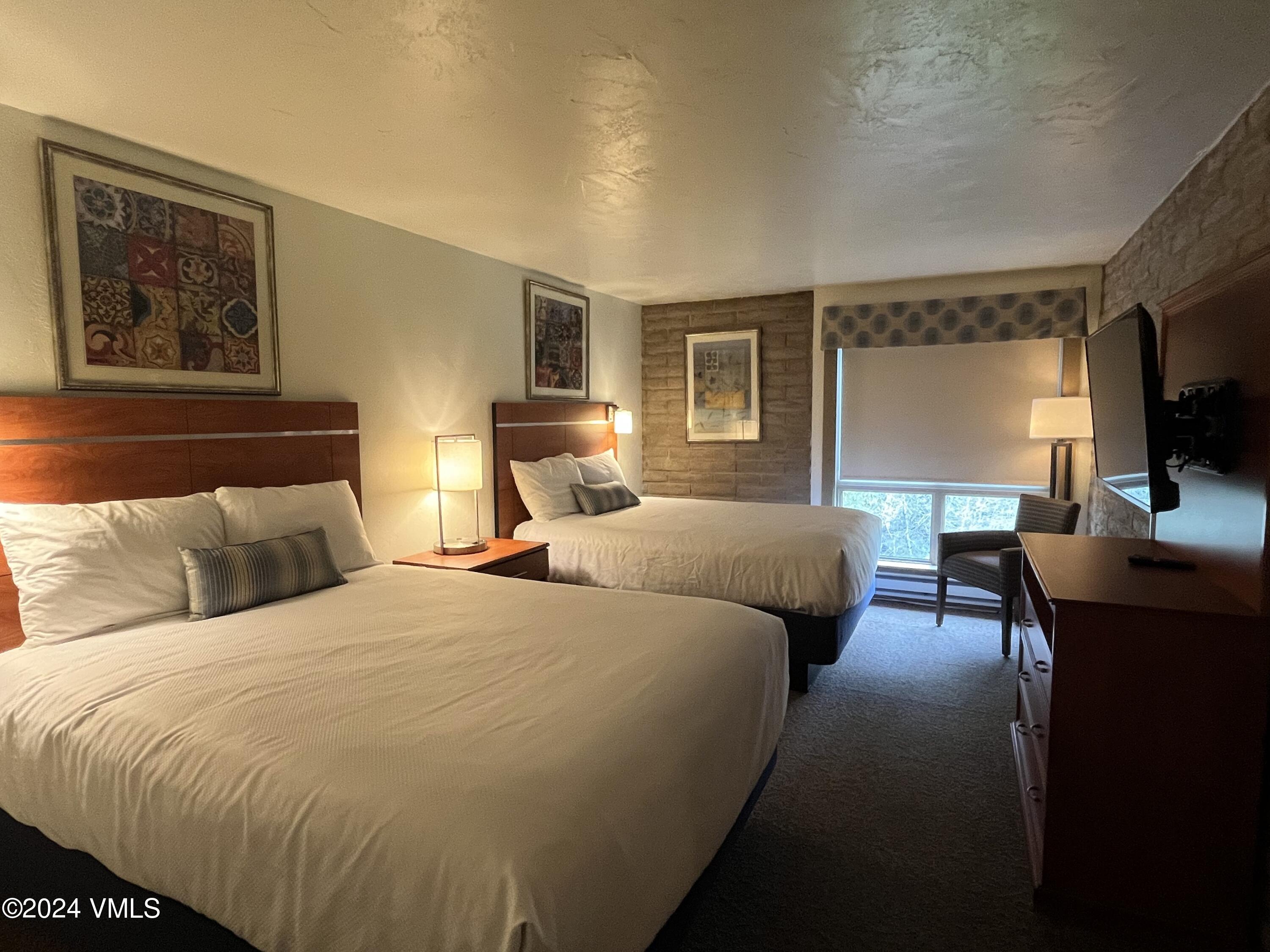 1020 Vail View Drive, Unit 221220 Vail, CO 81657 - Photo 10 of 22 a bedroom with double bed and a flat screen tv