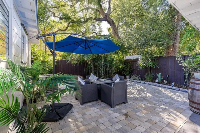 a view of a patio with couches and potted plants