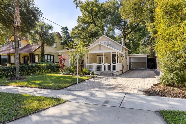 a front view of a house with yard and green space