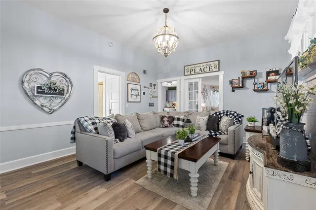a living room with furniture a clock and a window
