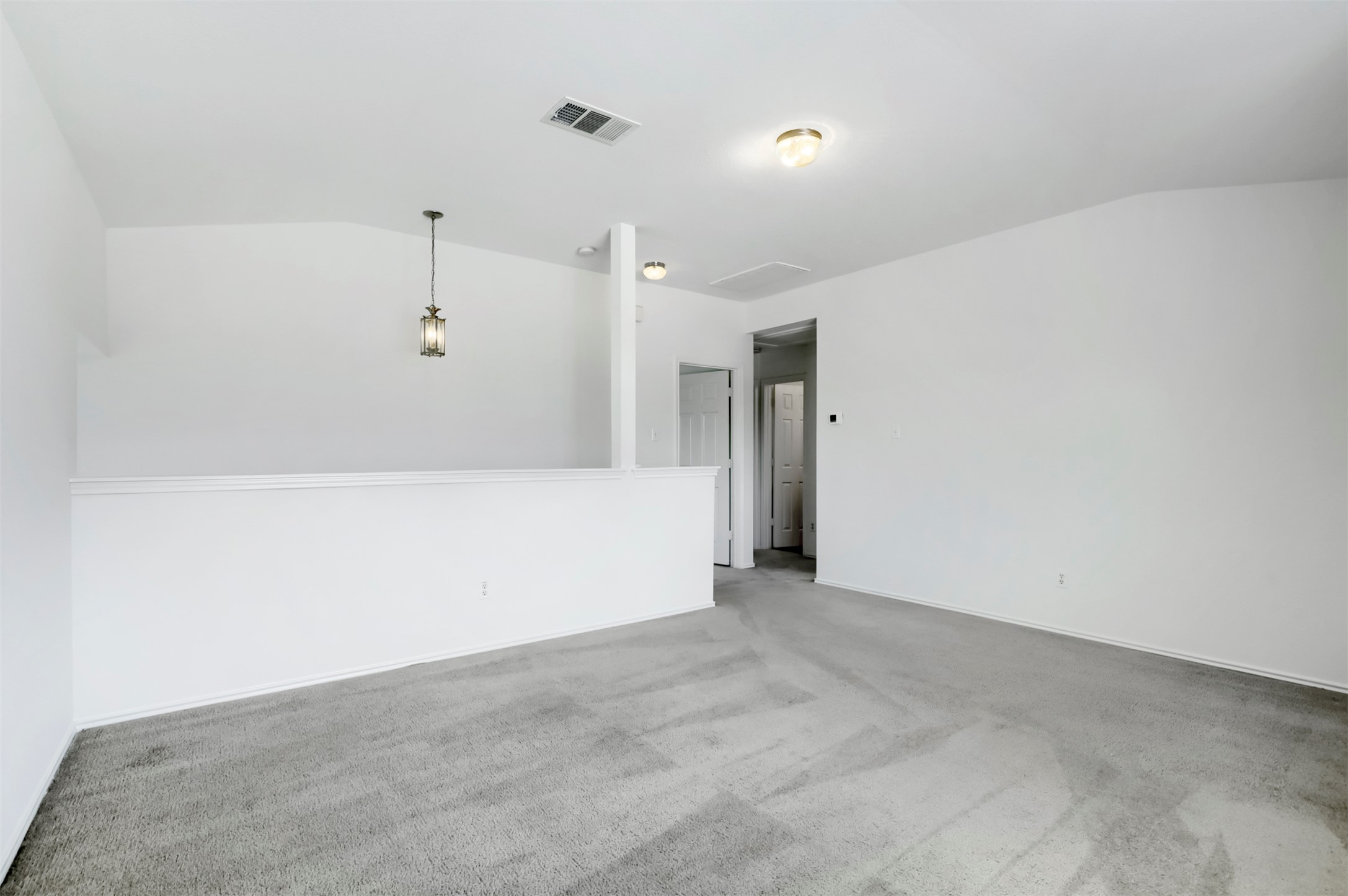 4125 Pebble Ridge Cove Round Rock, TX 78681 - Photo 15 of 30 A spacious loft area offers versatile living space with light-colored carpeting.