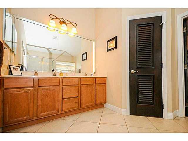 2183 Southwest Panther Trace Stuart, FL 34997 - Photo 16 of 25 a bathroom with a sink a vanity and a mirror