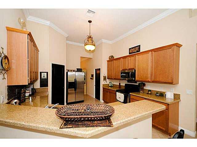 2183 Southwest Panther Trace Stuart, FL 34997 - Photo 7 of 25 a kitchen with a refrigerator and a stove