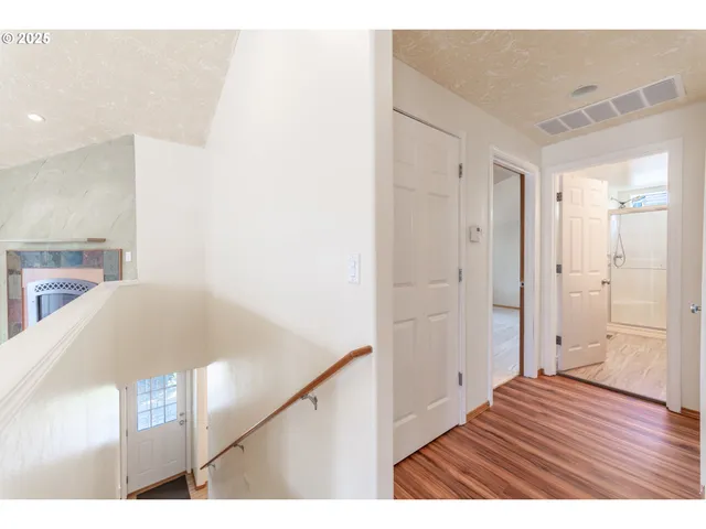 a view of an empty room and wooden floor