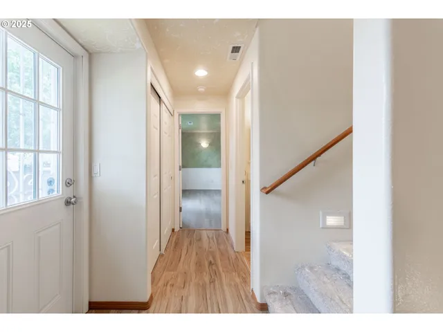 a view of hallway with wooden floor