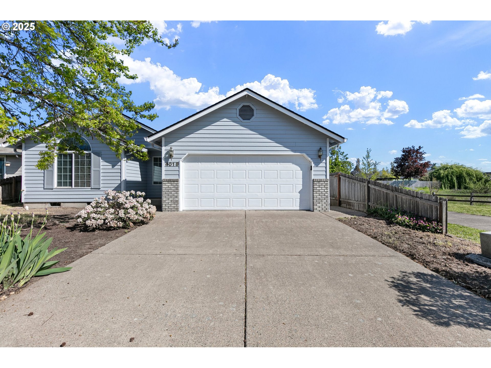 4018 Forsythia Street Springfield, OR 97478 - Photo 1 of 39 a view of a house with a yard and garage