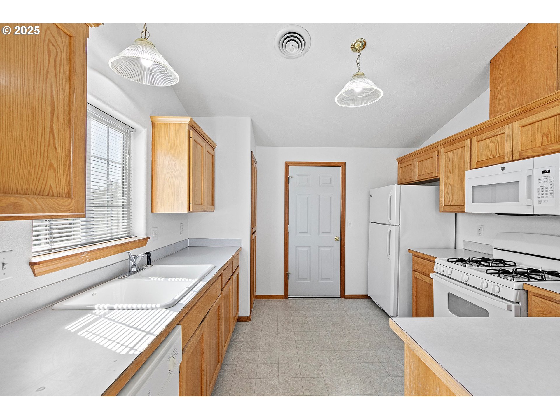 4018 Forsythia Street Springfield, OR 97478 - Photo 11 of 39 a kitchen with stainless steel appliances granite countertop a sink and a stove