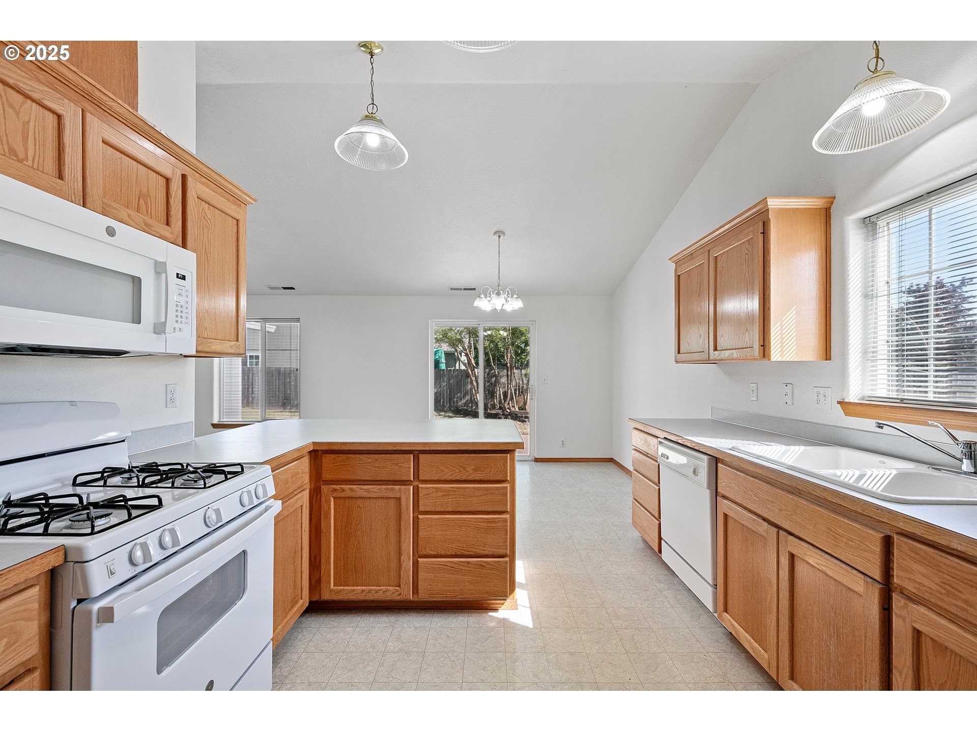 4018 Forsythia Street Springfield, OR 97478 - Photo 12 of 39 a kitchen with stainless steel appliances granite countertop a stove a sink and a refrigerator