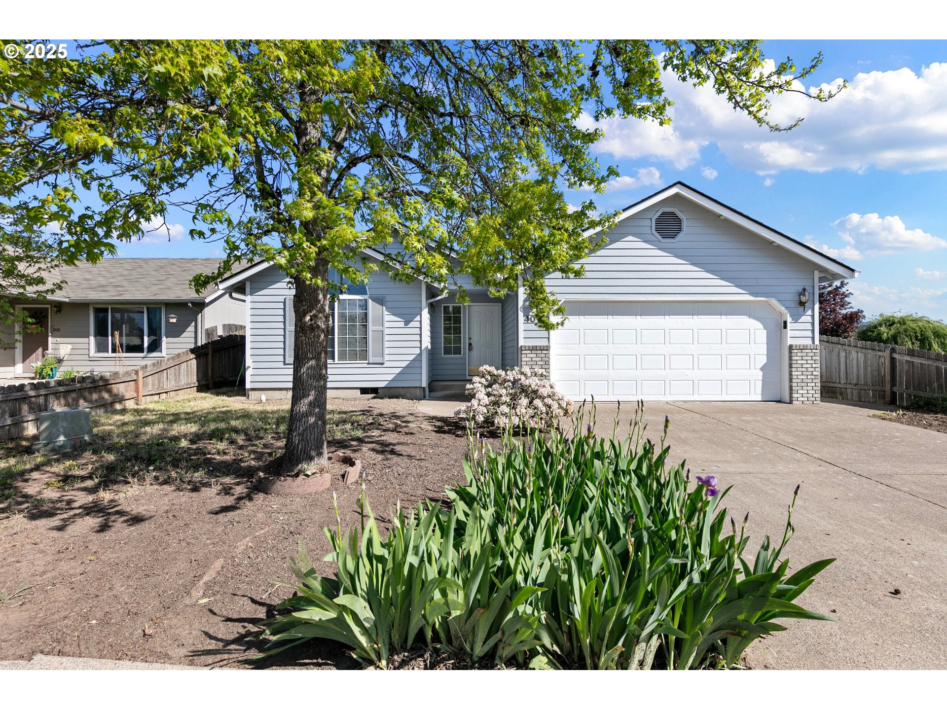 4018 Forsythia Street Springfield, OR 97478 - Photo 2 of 39 a front view of a house with a yard and garage