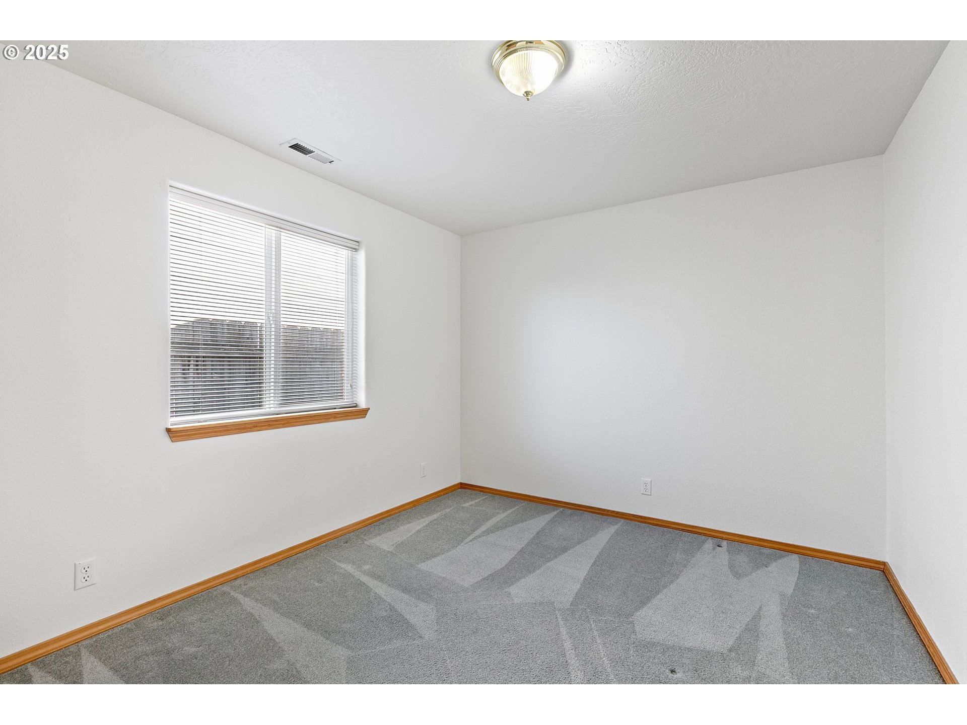 4018 Forsythia Street Springfield, OR 97478 - Photo 27 of 39 a view of an empty room with a window