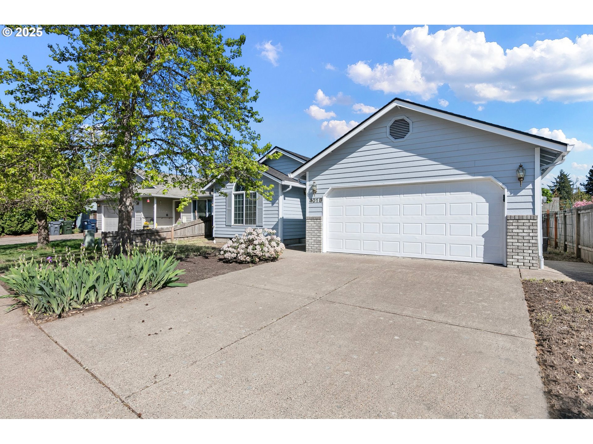 4018 Forsythia Street Springfield, OR 97478 - Photo 3 of 39 a front view of a house with a yard and garage