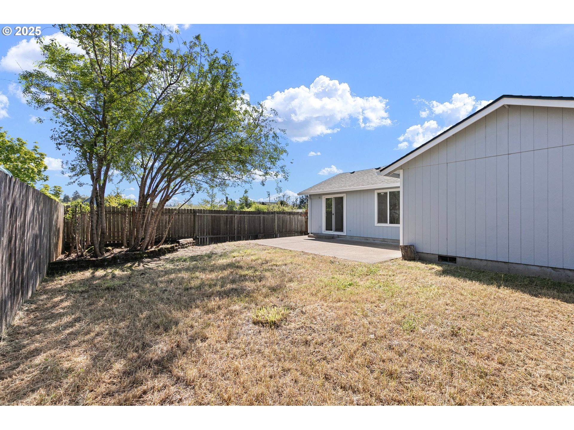4018 Forsythia Street Springfield, OR 97478 - Photo 35 of 39 a view of a backyard with a barbeque and wooden fence