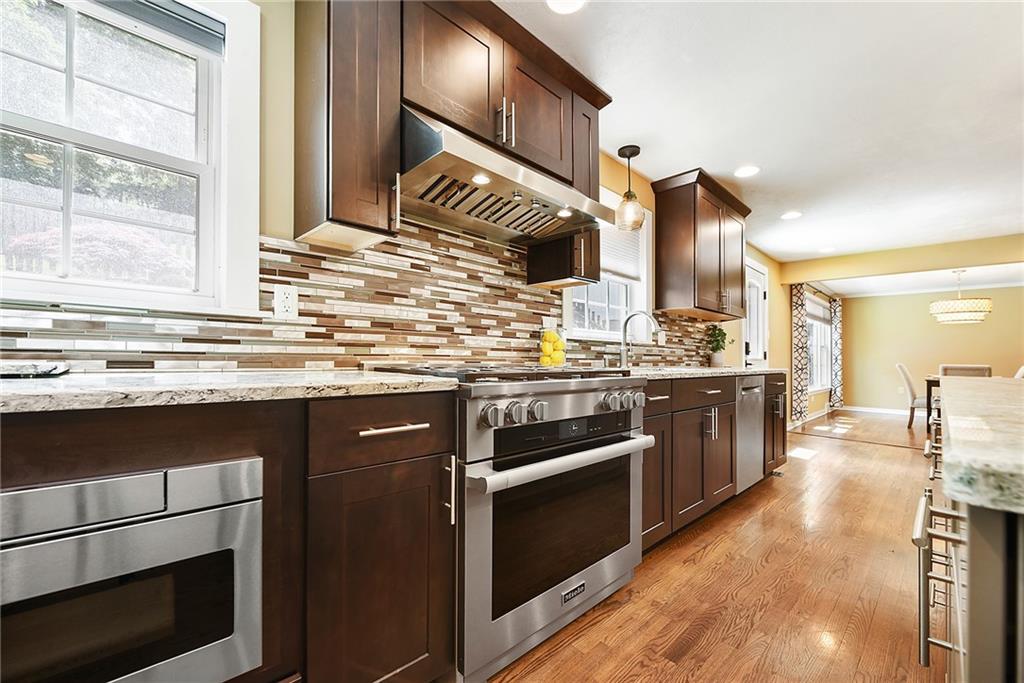 719 Pinetree Road Pittsburgh, PA 15243 - Photo 13 of 35 a kitchen with stainless steel appliances kitchen island granite countertop a stove a sink and a microwave