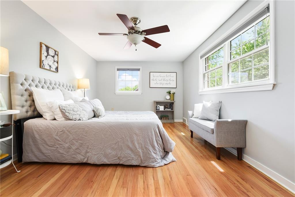 719 Pinetree Road Pittsburgh, PA 15243 - Photo 19 of 35 a bedroom with a bed and wooden floor