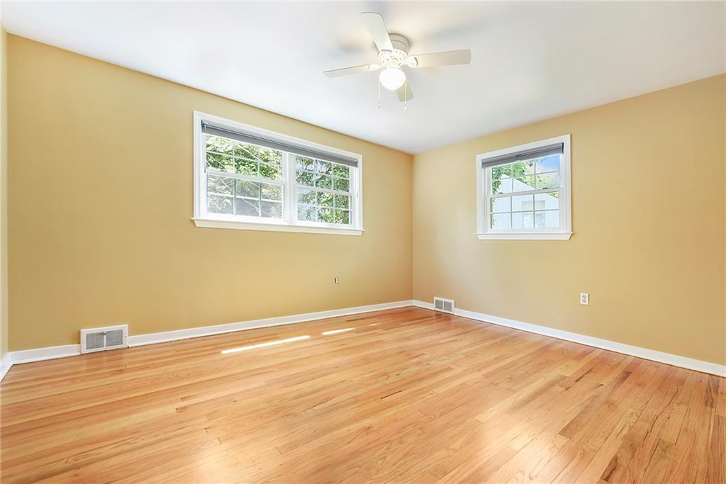 719 Pinetree Road Pittsburgh, PA 15243 - Photo 22 of 35 a view of an empty room with wooden floor and a window