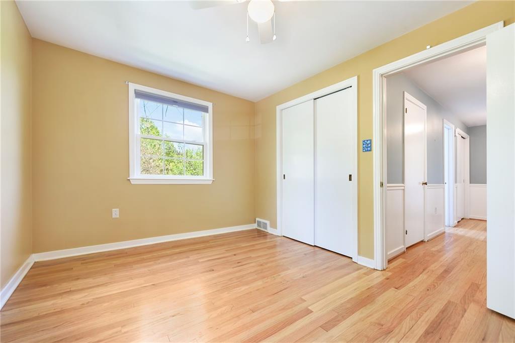 719 Pinetree Road Pittsburgh, PA 15243 - Photo 24 of 35 a view of an empty room with wooden floor and a window